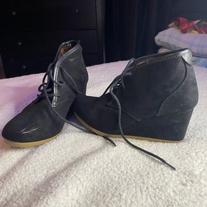 Black heal ankle boots with a lace up half way up. Small scratch on one